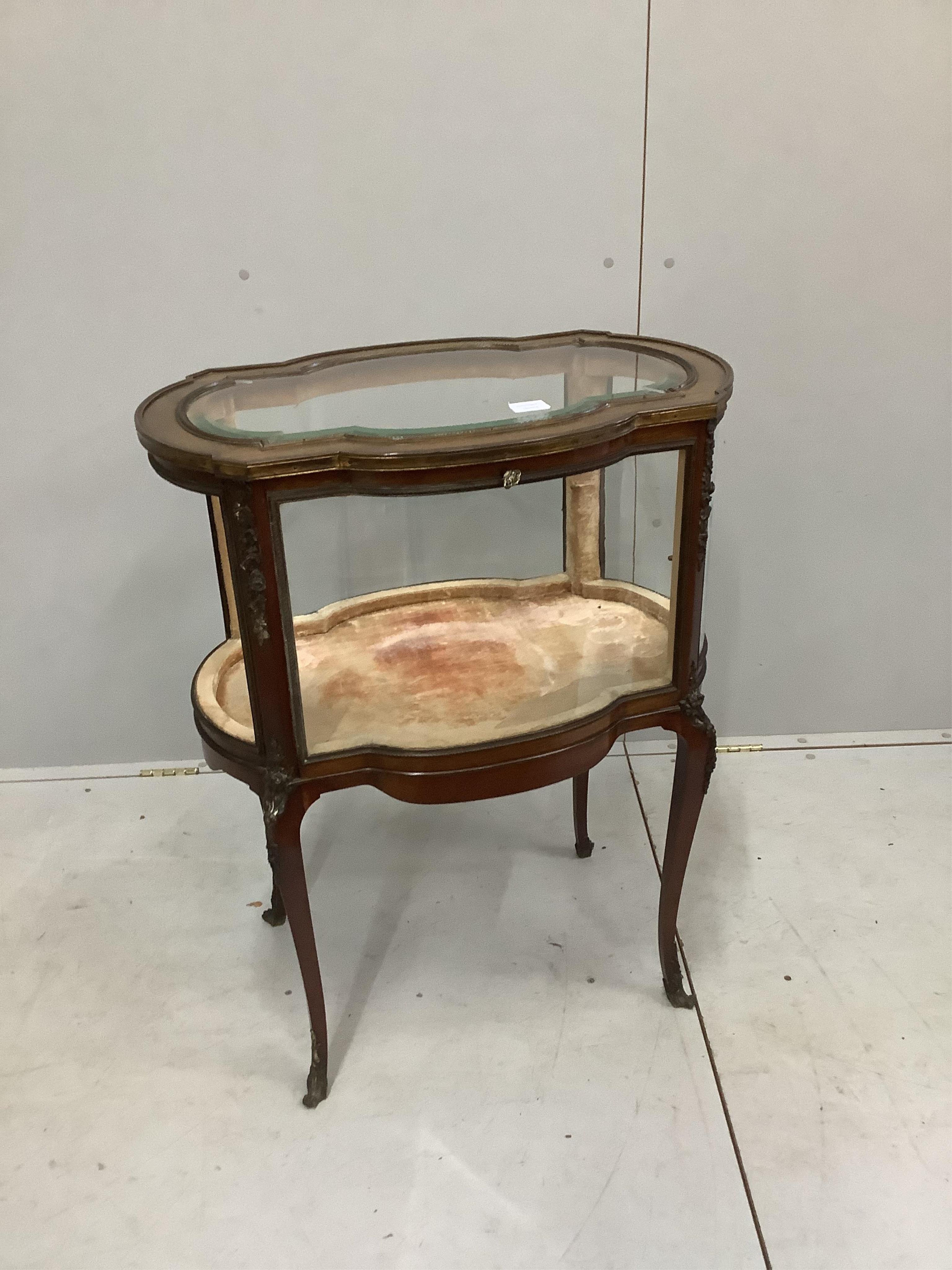 An early 20th century gilt metal mounted mahogany bijouterie cabinet, (one glass panel missing), width 68cm, depth 46cm, height 86cm. Condition - fair